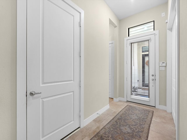 doorway to outside featuring light tile patterned floors