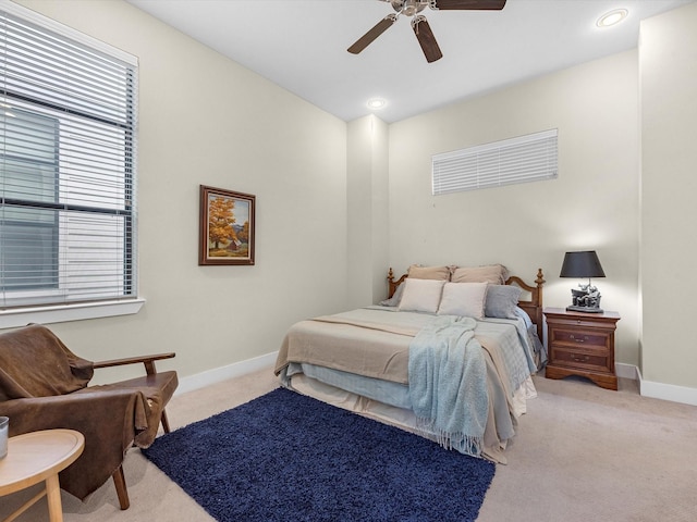 bedroom with ceiling fan and light colored carpet