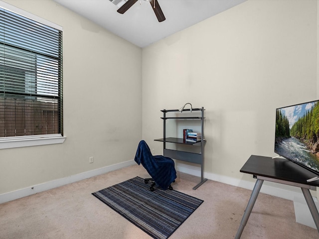 office space featuring light carpet and ceiling fan