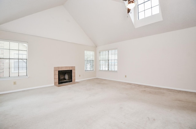 unfurnished living room with carpet, ceiling fan, a fireplace, and vaulted ceiling