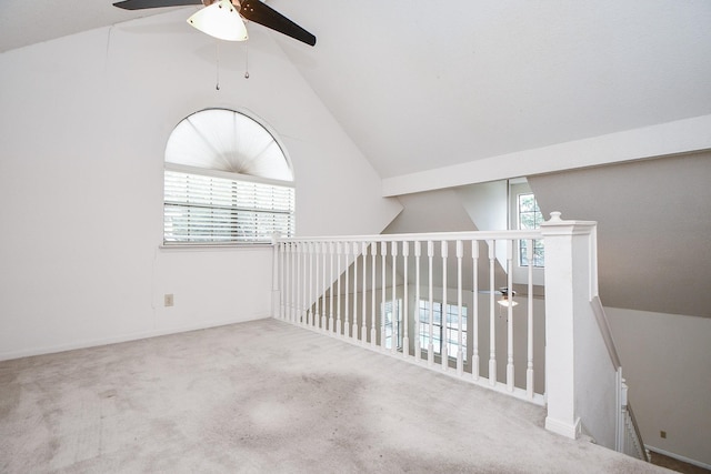 hall featuring carpet and vaulted ceiling