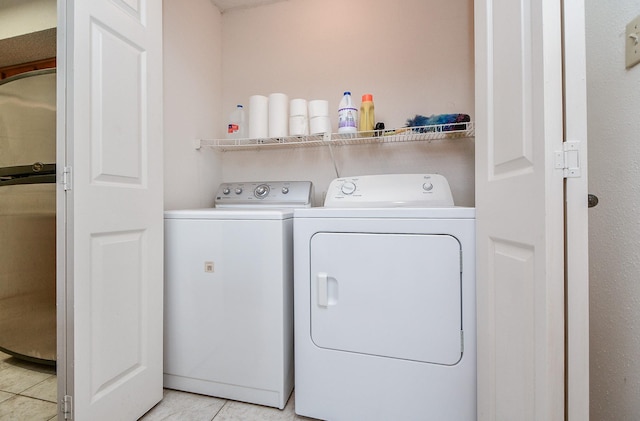 washroom with separate washer and dryer and light tile patterned floors