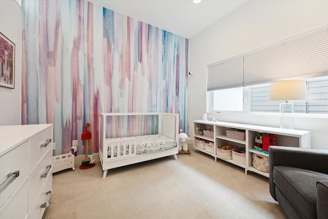 bedroom featuring light colored carpet and a crib