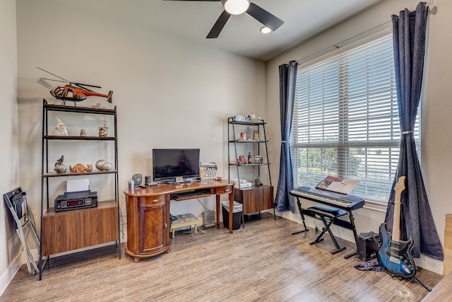 home office featuring light wood-type flooring and ceiling fan