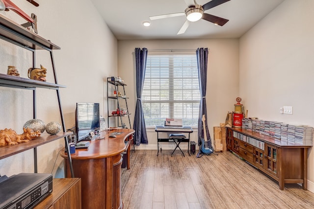 office with light hardwood / wood-style floors, ceiling fan, and a healthy amount of sunlight