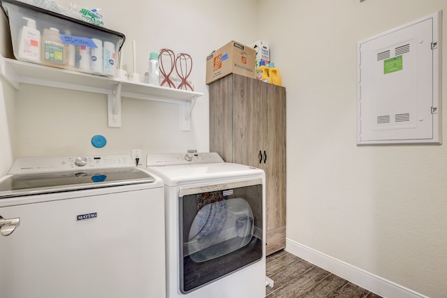 clothes washing area with dark hardwood / wood-style flooring and washing machine and clothes dryer