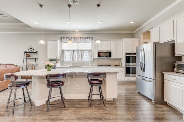 kitchen featuring a kitchen breakfast bar, stainless steel appliances, and a kitchen island