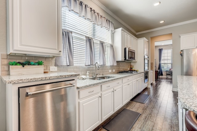 kitchen featuring white cabinets, light stone countertops, sink, and appliances with stainless steel finishes