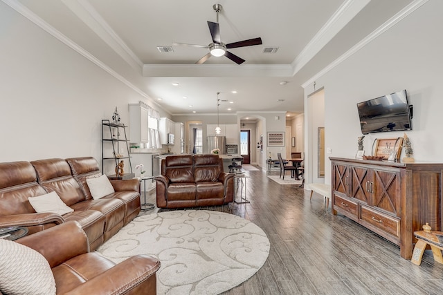 living room with ceiling fan, hardwood / wood-style floors, and ornamental molding