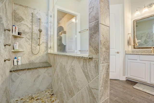 bathroom with vanity and tiled shower