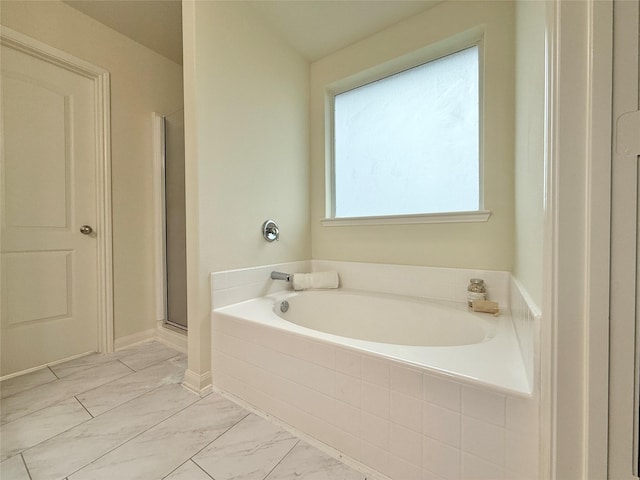 bathroom with separate shower and tub and a healthy amount of sunlight