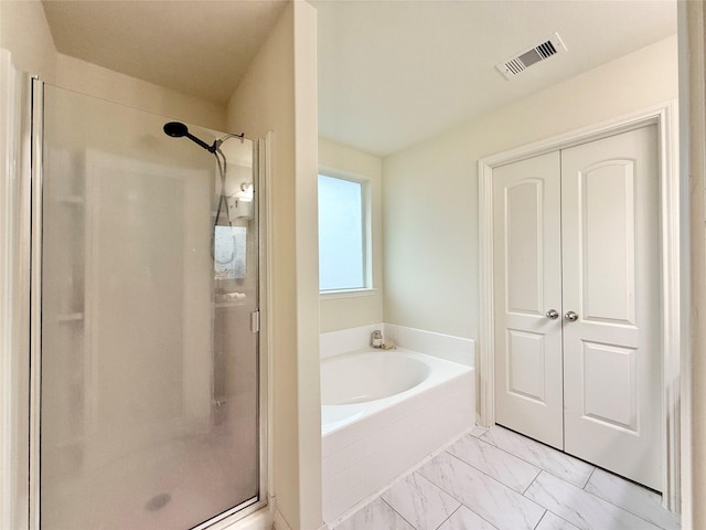 bathroom with separate shower and tub