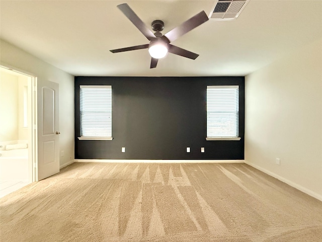 unfurnished room with ceiling fan and light colored carpet