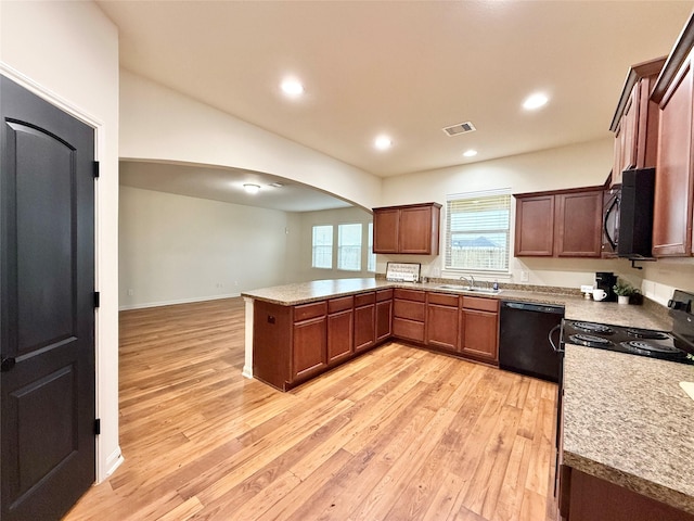 kitchen featuring kitchen peninsula, sink, light hardwood / wood-style floors, and black appliances