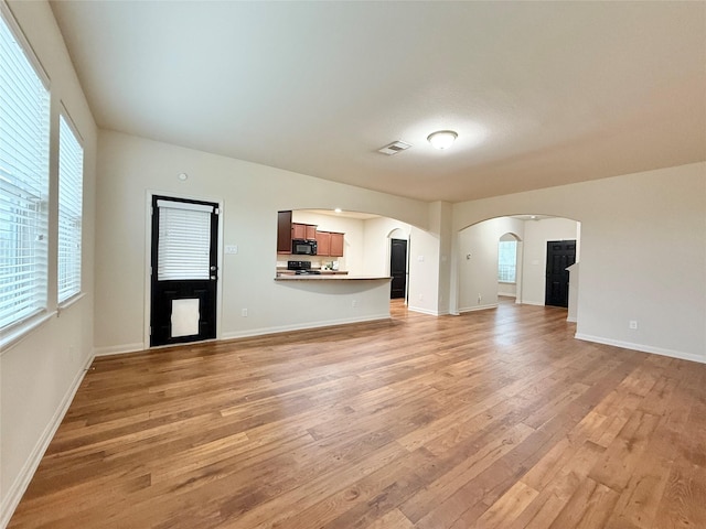 unfurnished living room featuring light wood-type flooring