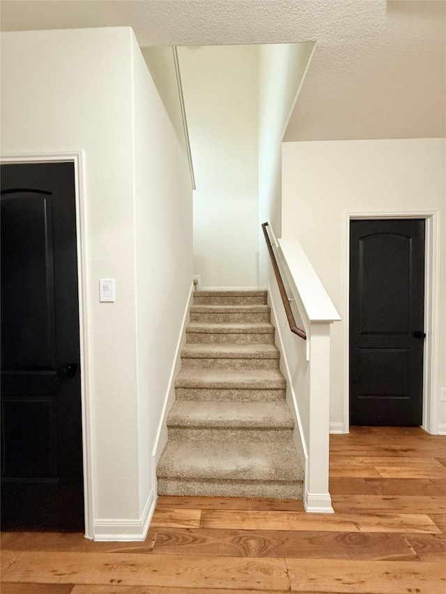 staircase featuring hardwood / wood-style floors