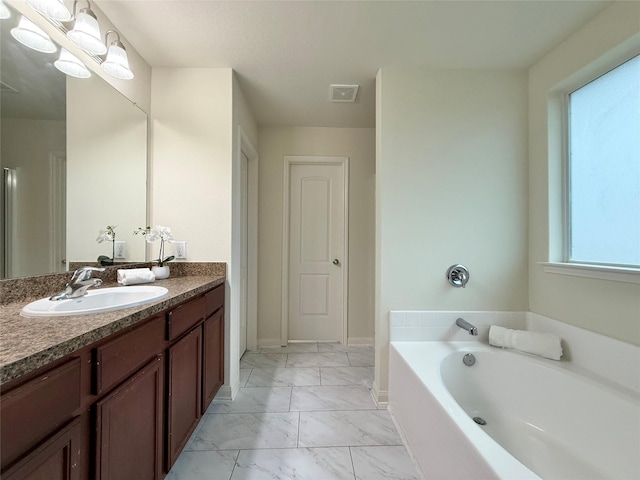 bathroom with vanity and a bathtub