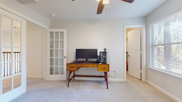 carpeted office space with french doors and ceiling fan