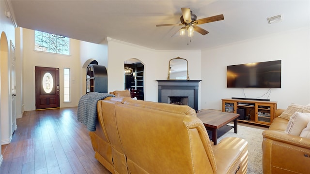 living room with a fireplace, hardwood / wood-style floors, a wealth of natural light, and ceiling fan