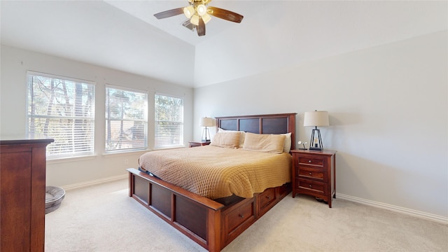 bedroom featuring ceiling fan, lofted ceiling, and light carpet