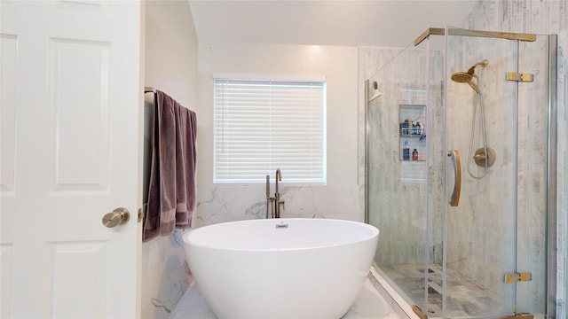 bathroom featuring a wealth of natural light and independent shower and bath