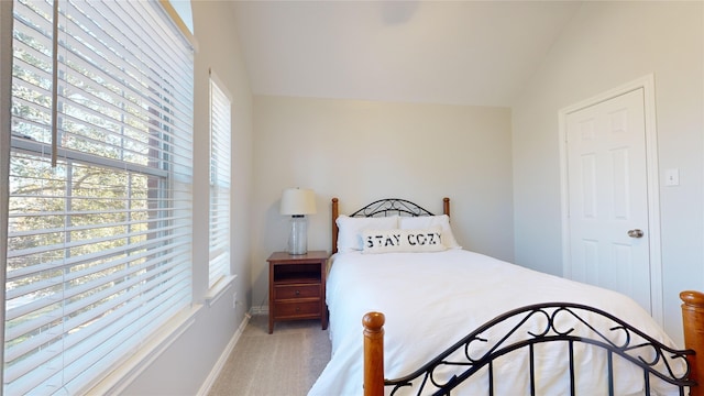 carpeted bedroom featuring lofted ceiling