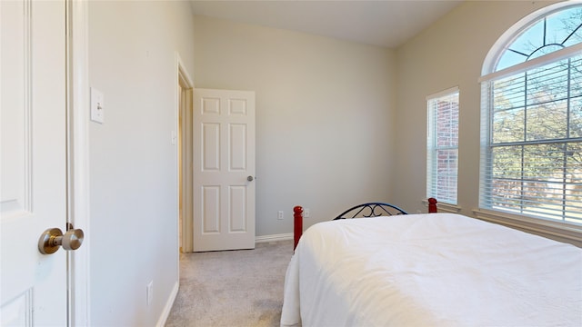 carpeted bedroom with vaulted ceiling