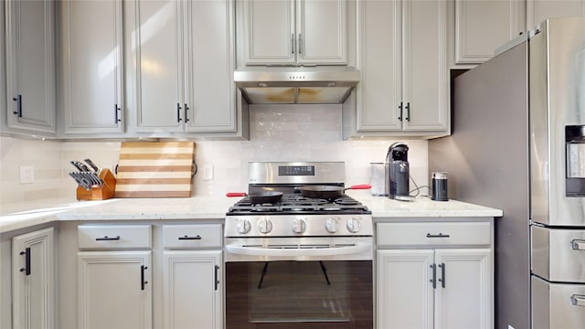 kitchen with decorative backsplash, light stone counters, and appliances with stainless steel finishes