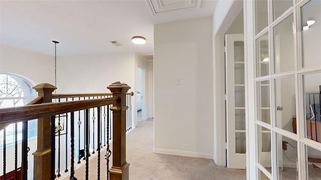 hall with light colored carpet