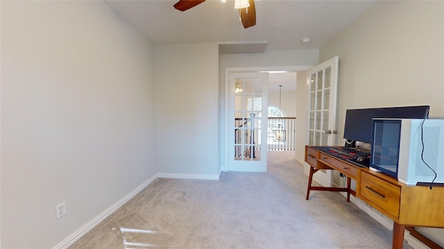 home office featuring french doors, light colored carpet, and ceiling fan