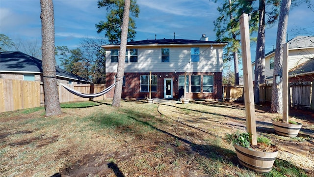 rear view of house with a lawn