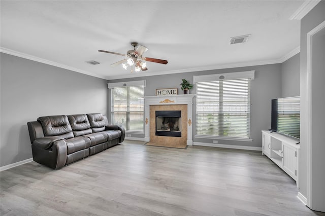 living room with light wood-type flooring, ceiling fan, and crown molding