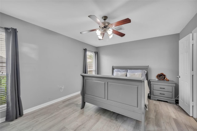 bedroom with ceiling fan and light hardwood / wood-style floors