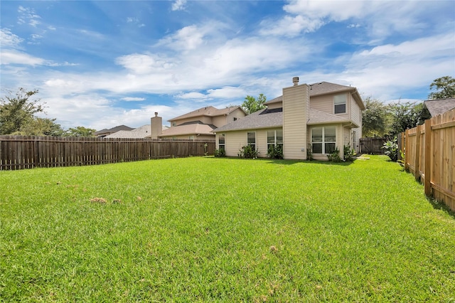 back of property with a lawn