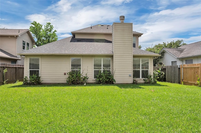 rear view of property with a yard