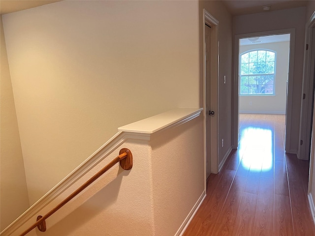 corridor with hardwood / wood-style flooring