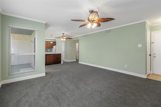 unfurnished living room featuring carpet floors, ceiling fan, and ornamental molding