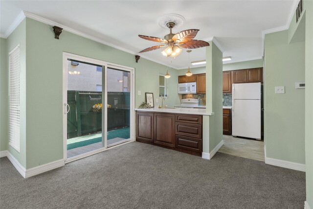 kitchen featuring backsplash, ornamental molding, white appliances, light colored carpet, and ceiling fan