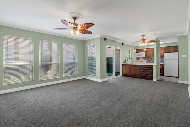 unfurnished living room with carpet flooring, crown molding, and ceiling fan