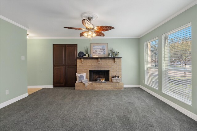 unfurnished living room with crown molding, a fireplace, carpet floors, and ceiling fan