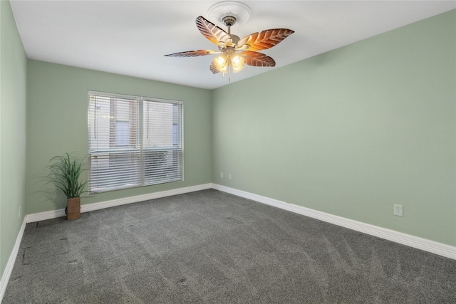 unfurnished room with dark colored carpet and ceiling fan