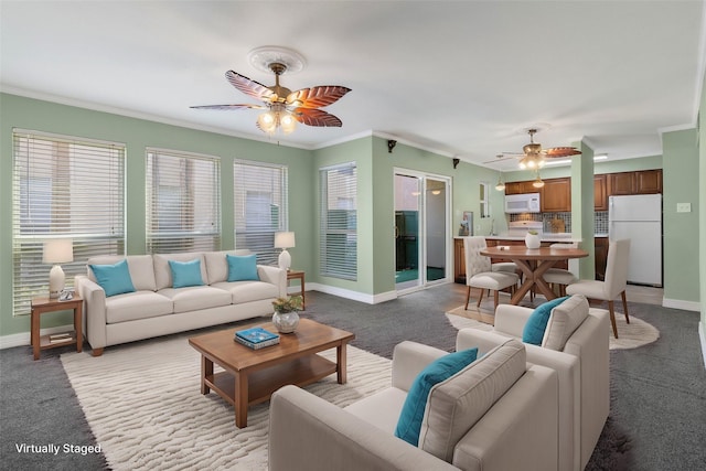 living room with ceiling fan, light colored carpet, and ornamental molding