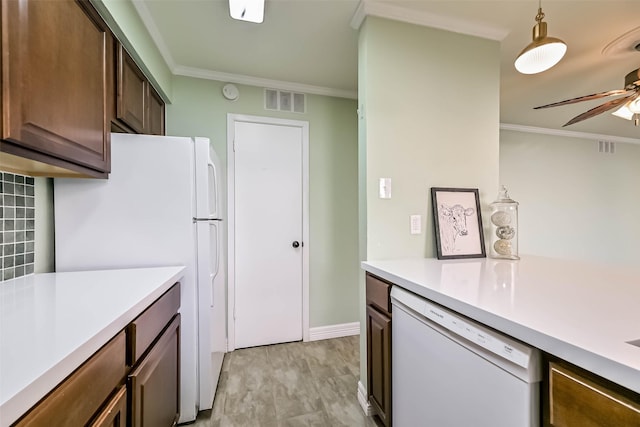 kitchen with crown molding, white appliances, light countertops, and ceiling fan