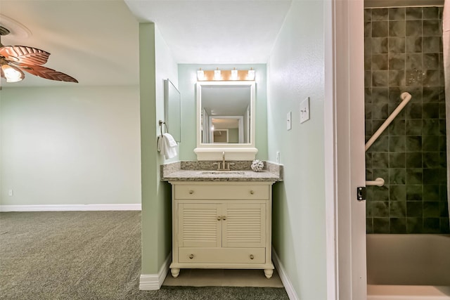 bathroom featuring vanity, shower / washtub combination, baseboards, and ceiling fan