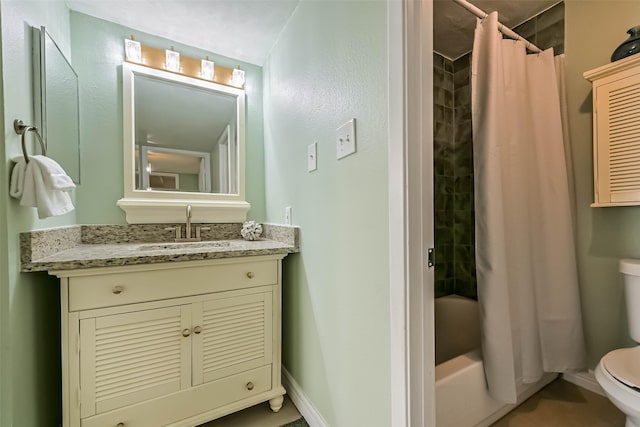 bathroom with toilet, vanity, baseboards, and shower / tub combo