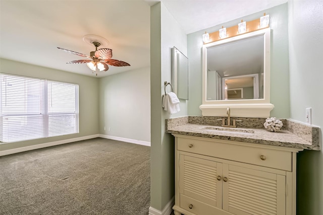 bathroom featuring baseboards, vanity, and a ceiling fan