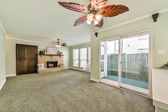 unfurnished living room with a brick fireplace, crown molding, carpet, and ceiling fan