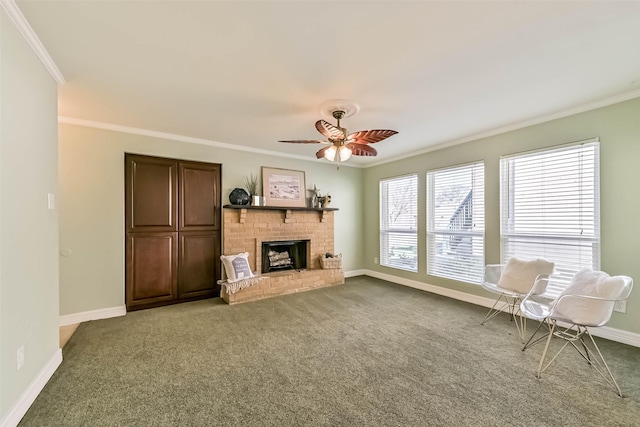 carpeted living area featuring baseboards, a fireplace, ceiling fan, and crown molding