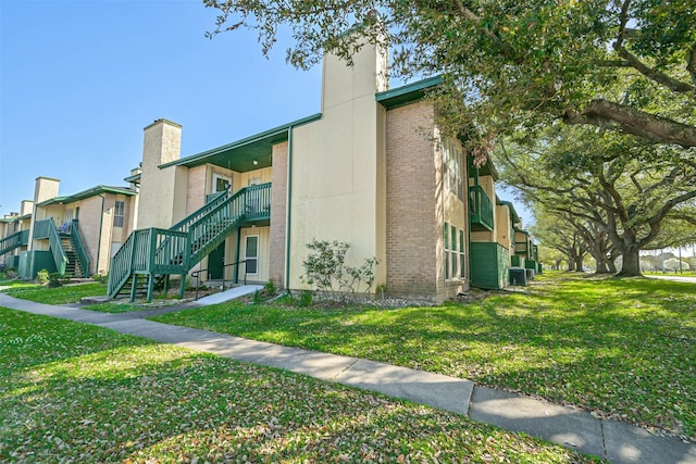 view of property with central AC and stairway