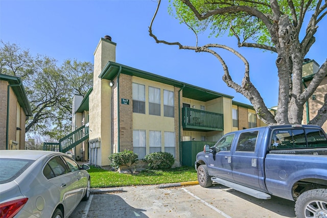 view of building exterior featuring uncovered parking